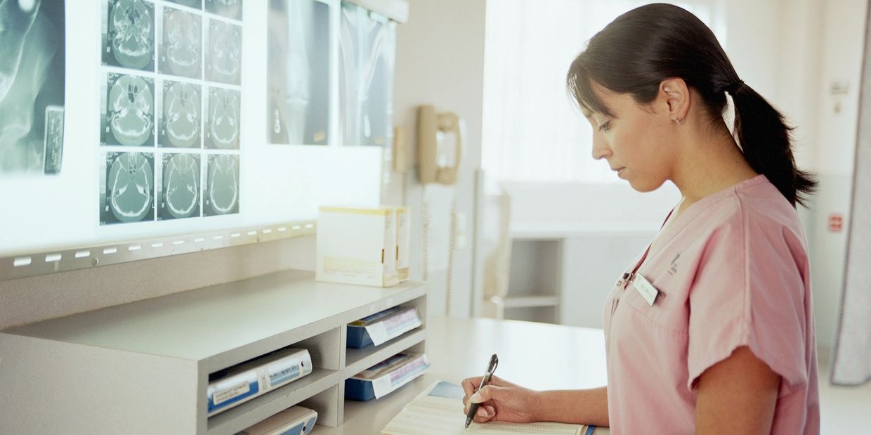 Nurse reviewing patient information in the back office of the clinic