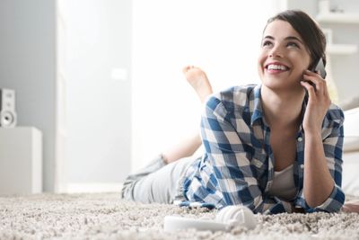 Lady laying down on carpet.