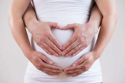 happy couple purchasing herbal remedies and maternity band from the ultrasound boutique