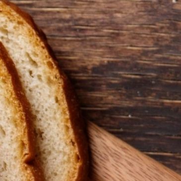 Close-up of sliced bread on a wooden surface.