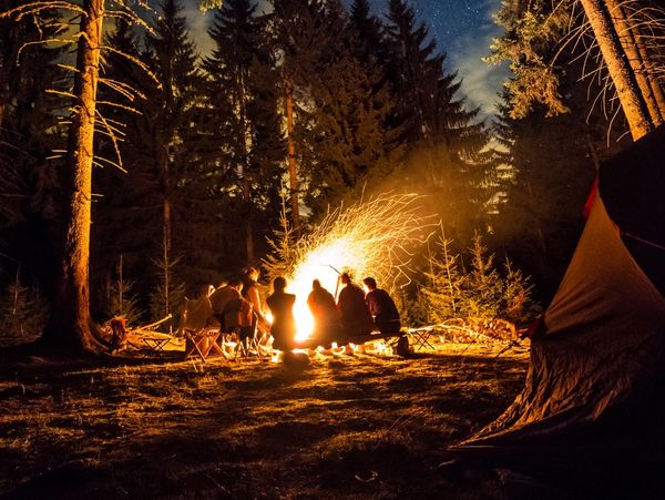 A group of people huddled around a campfire