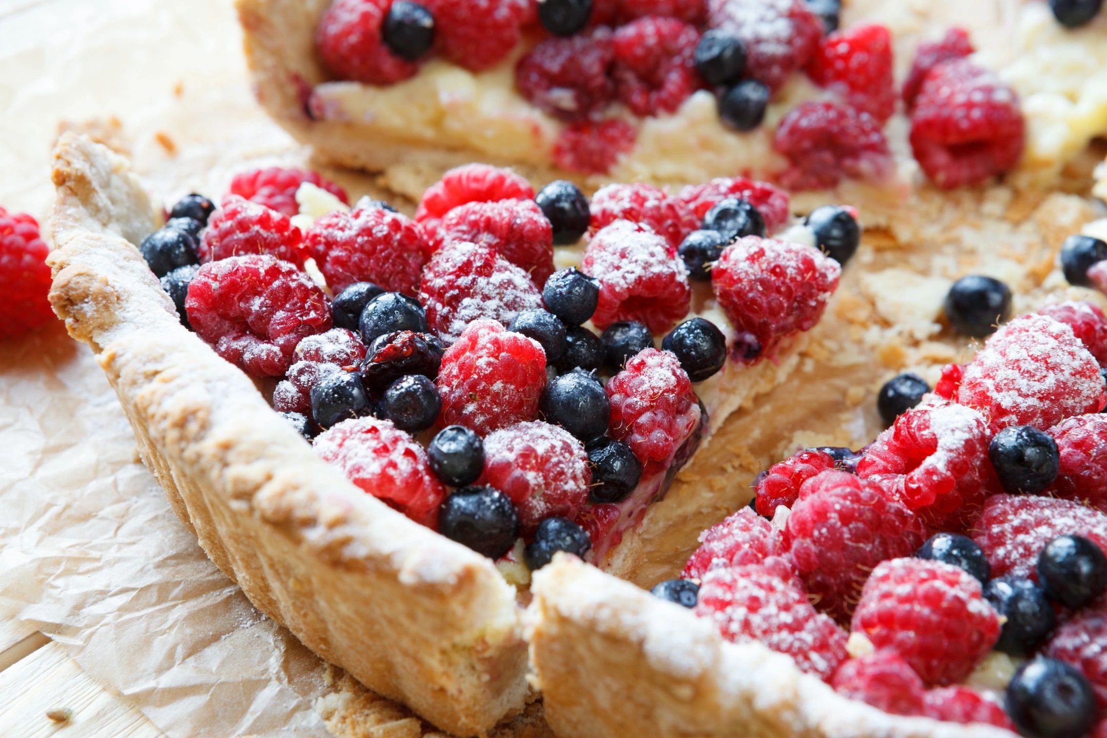 A delicious berry tart dusted with powdered sugar.