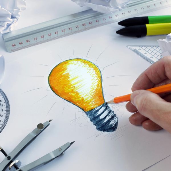 A person drawing a light bulb