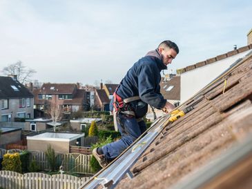 Roofer installing a roof