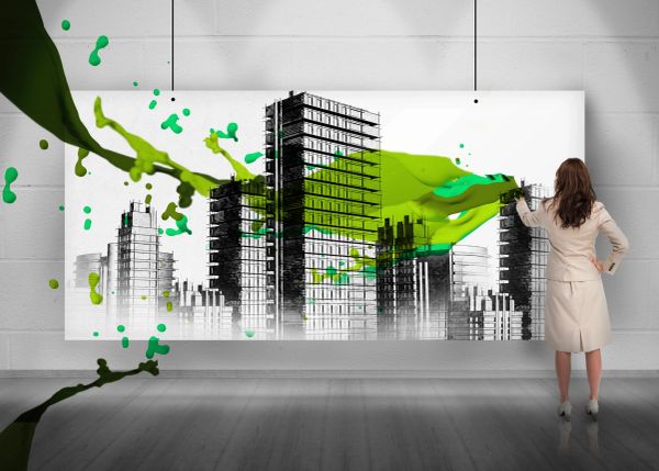 Woman painting green splash over black-and-white cityscape artwork.