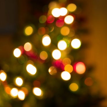 Blurred Christmas tree lights creating a festive bokeh effect.