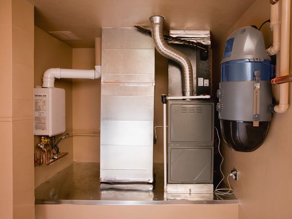 Utility room with furnace and water heater.