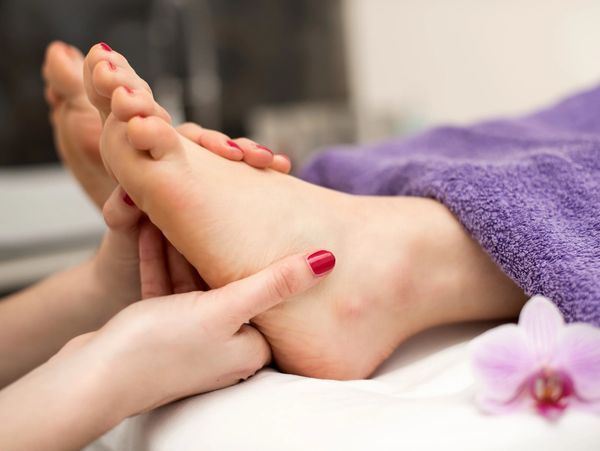 A reflexology treatment being performed on a client.