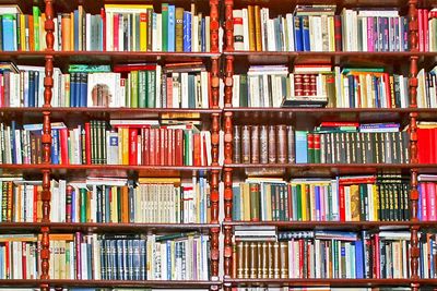 A large wooden bookshelf filled with various books.