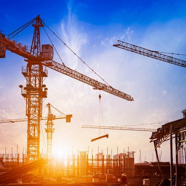 Multiple heavy high-rise cranes during construction at sunset. Los Angeles Southland Special Deputy 