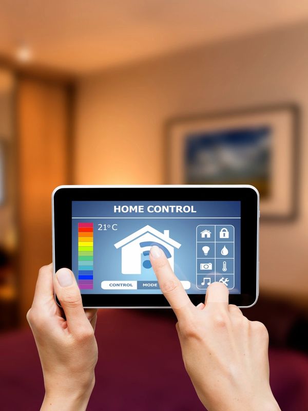 Person using a tablet for home control settings.