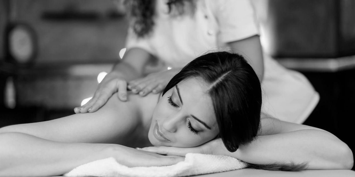 A cozy and warm atmosphere is shown with woman enjoying massage