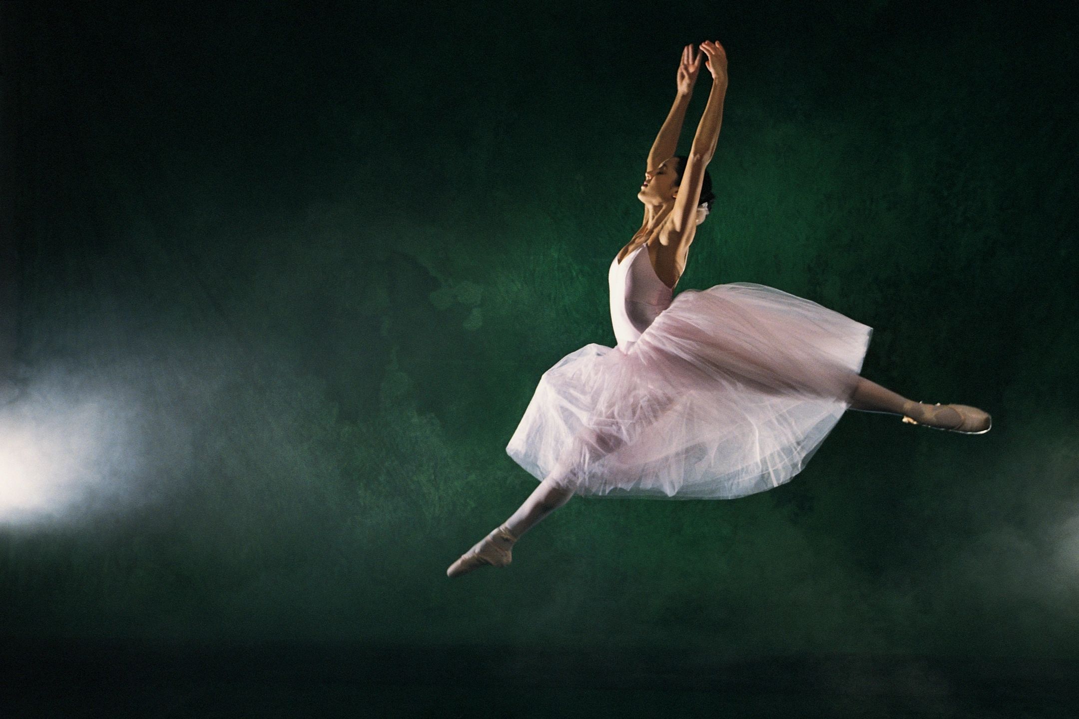 ballet dancer leaping in tutu and pointe shoes