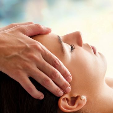 person receiving a reiki healing session for stress relief and relaxation