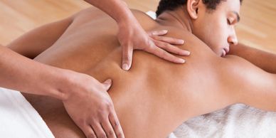 A massage therapist massaging a back