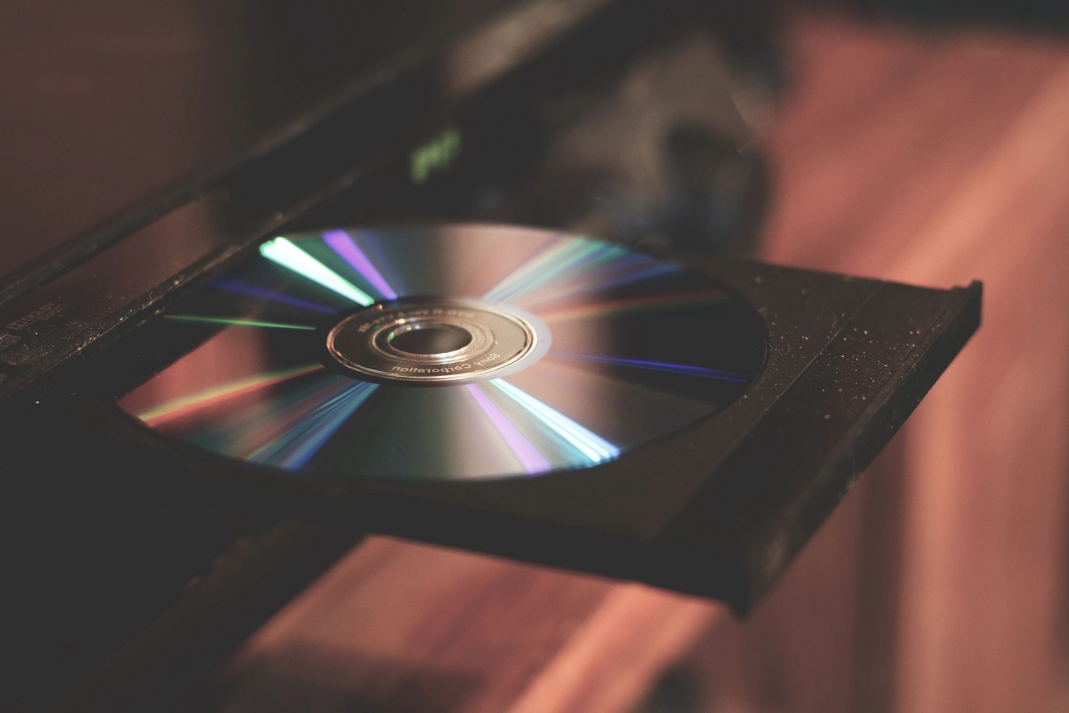 A picture of CD ejecting out of an audio disc player.