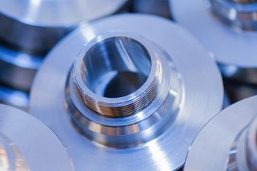 Close-up of a finely machined metal part with threaded section.