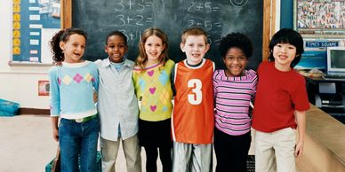 group of students standing in front of chalkboard