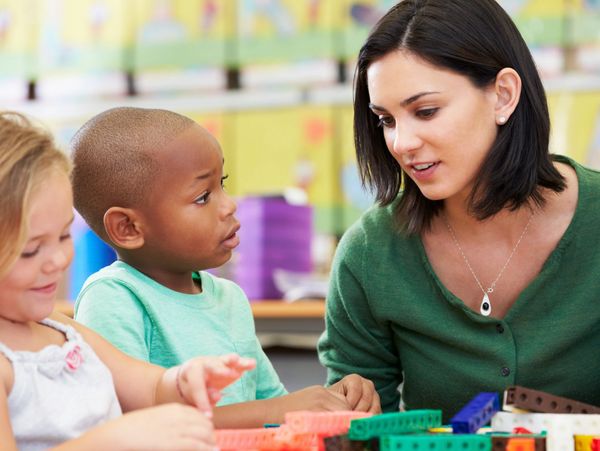 Teacher engaging with children during an educational activity.