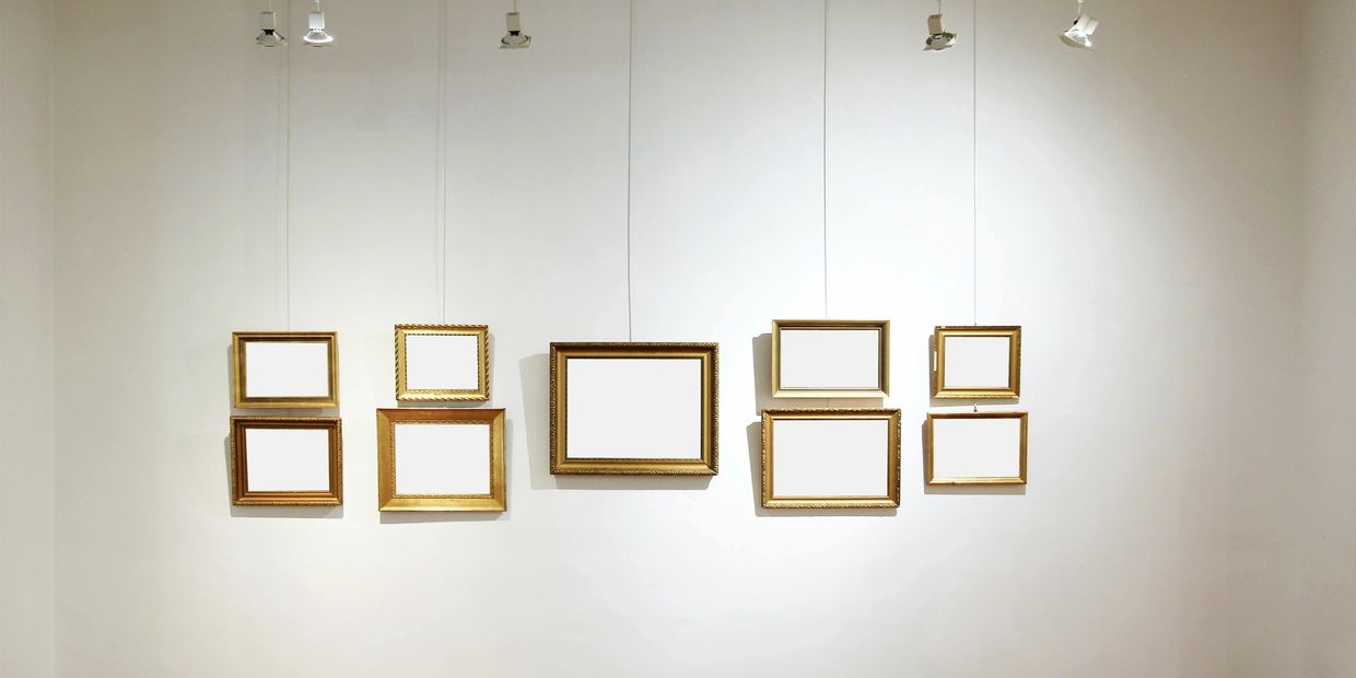 many golden frames in a museum