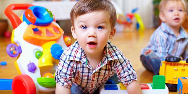 A young boy playing with colorful toys.