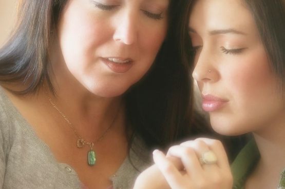 Mother and daughter praying together