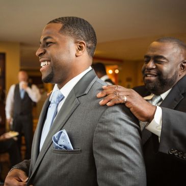 Black men together smiling and laughing. 