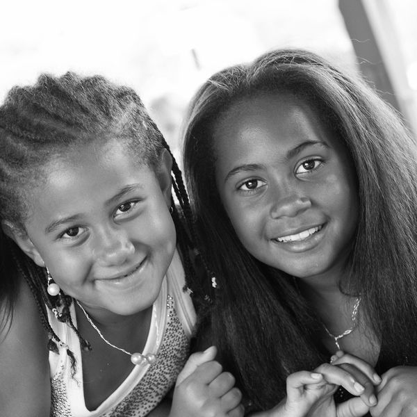 Two young girls smiling and happy
