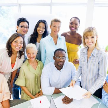 a group of people in a office are looking into camera 