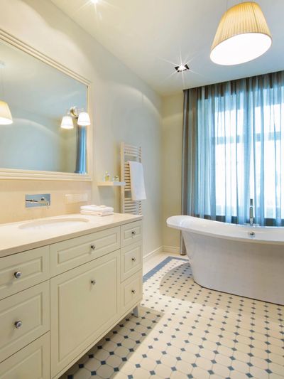 Pristine bathroom with white cabinets and sink. Keep it spotless with regular cleaning services