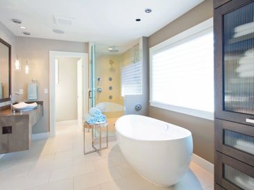 Modern bathroom with a freestanding bathtub and glass shower.