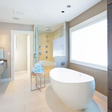 Modern bathroom with a freestanding tub and glass shower.
