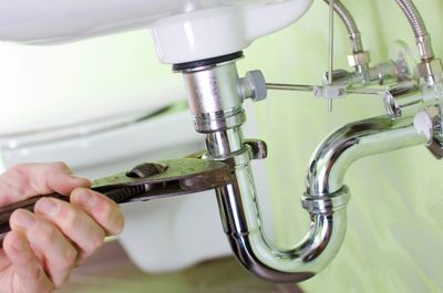 man fixing basin waste