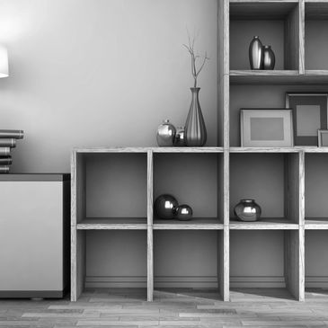 Modern wooden shelving with decorative vases, books, and a lamp on a sideboard.