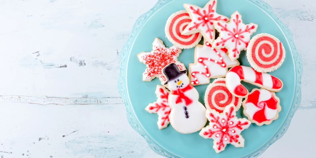 Festive Christmas cookies on a blue plate.