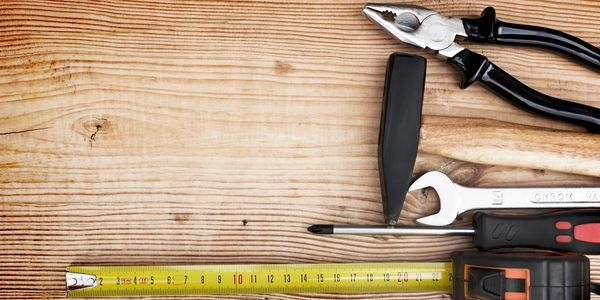 A wooden table full of carpentry equipment.