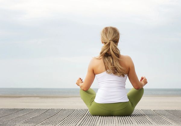 A blond-haired woman meditating