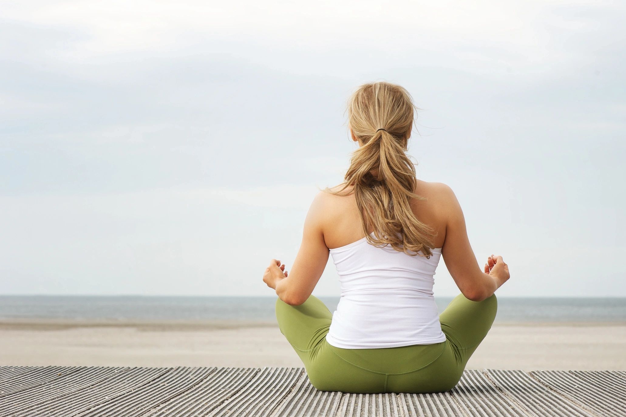 Seated woman in good posture facing away. 