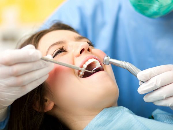 Woman receives dental check in a stomatology clinic.