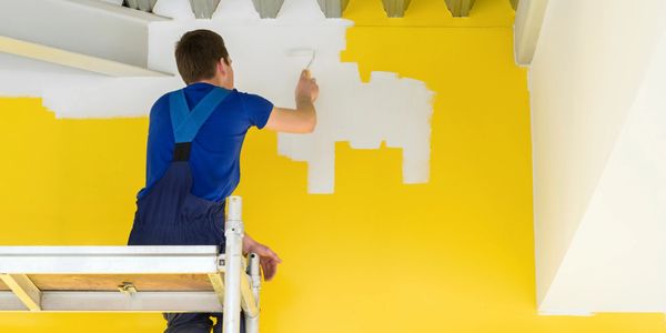 A person painting a wall