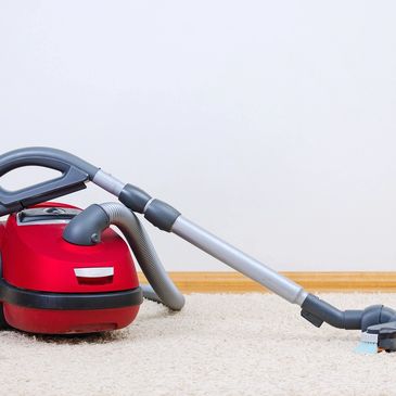 springtime cleaning red vacuum on the carpet