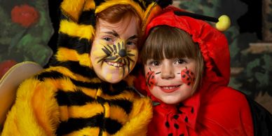 Two children in bee and ladybug costumes.