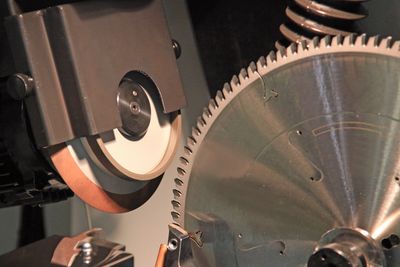 Picture of mitre saw blade being sharpened