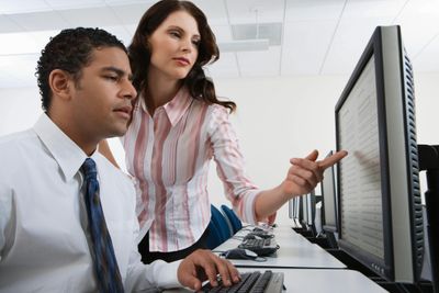 Two people looking at computer screen