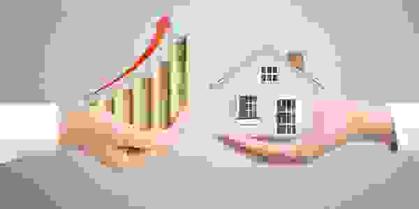 a hand holding property and a hand holding cash increasing