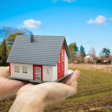A set of hands holding a home with a view of the gardens