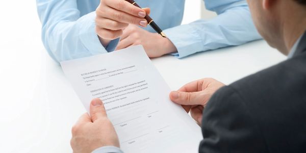 a man looking at a signed document