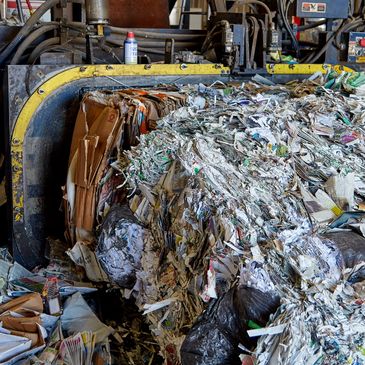 Large bale of compressed recycled paper in a recycling facility.