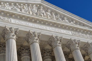 The facade of a classical courthouse with the inscription 'Equal Justice Under Law'.