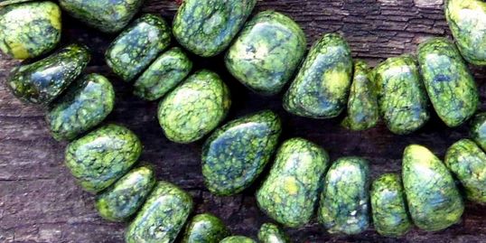 Image of green beads close together to represent Manaakitanga or togetherness